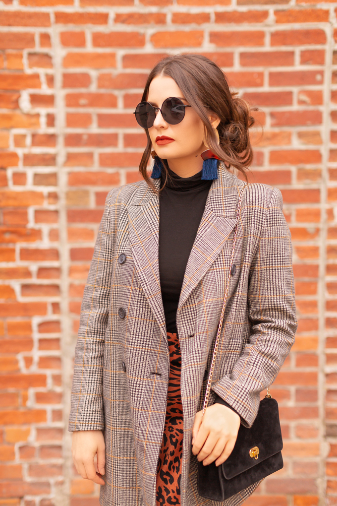 Autumn 2019 Lookbook: Cheetah Chic | Top Fall / Winter 2019 Trends | Top Autumn 2019 Trends and How to Wear Them | Brunette woman wearing a burnt orange cheetah print satin midi skirt, black turtleneck, oversized plaid blazer, black velvet sandals and a vintage suede bag | Chic Fall / Winter 2019 Evening Outfits | How to Style Cheetah Print | How to Style Boyfriend Blazers | How to Mix Prints | Top Calgary Fashion & Creative Lifestyle Blogger // JustineCelina.com