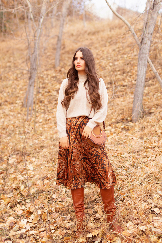 Autumn 2019 Lookbook: Equestrian Influence | Top Fall / Winter 2019 Trends | Top Autumn 2019 Trends and How to Wear Them | H&M x Richard Allen Collection Review | Brunette woman wearing H&M x Richard Allen Skirt with Belt, Cognac Corduroy Blazer, H&M Fine Knit Swearer in Beige and Lucky Brand Azoola Boots surrounded by fall leaves | Bohemian Fall / Winter 2019 Outfits | How to Style Paisley | How to Style Corduroy Top Calgary Fashion & Creative Lifestyle Blogger // JustineCelina.com