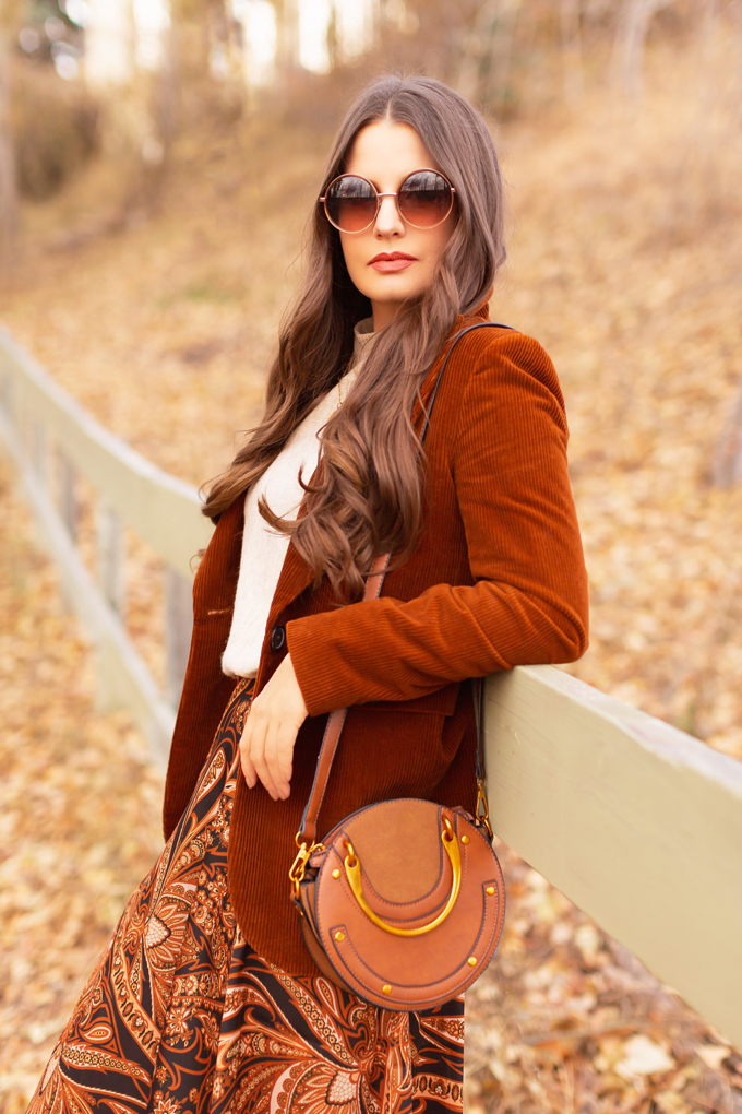 Autumn 2019 Lookbook: Equestrian Influence | Top Fall / Winter 2019 Trends | Top Autumn 2019 Trends and How to Wear Them | H&M x Richard Allen Collection Review | Brunette woman wearing H&M x Richard Allen Skirt with Belt, Cognac Corduroy Blazer, H&M Fine Knit Swearer in Beige and Lucky Brand Azoola Boots surrounded by fall leaves | Bohemian Fall / Winter 2019 Outfits | How to Style Paisley | How to Style Corduroy Top Calgary Fashion & Creative Lifestyle Blogger // JustineCelina.com