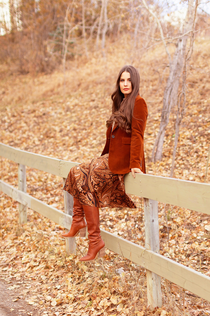 Autumn 2019 Lookbook: Equestrian Influence | Top Fall / Winter 2019 Trends | Top Autumn 2019 Trends and How to Wear Them | H&M x Richard Allen Collection Review | Brunette woman wearing H&M x Richard Allen Skirt with Belt, Cognac Corduroy Blazer, H&M Fine Knit Swearer in Beige and Lucky Brand Azoola Boots surrounded by fall leaves | Bohemian Fall / Winter 2019 Outfits | How to Style Paisley | How to Style Corduroy Top Calgary Fashion & Creative Lifestyle Blogger // JustineCelina.com