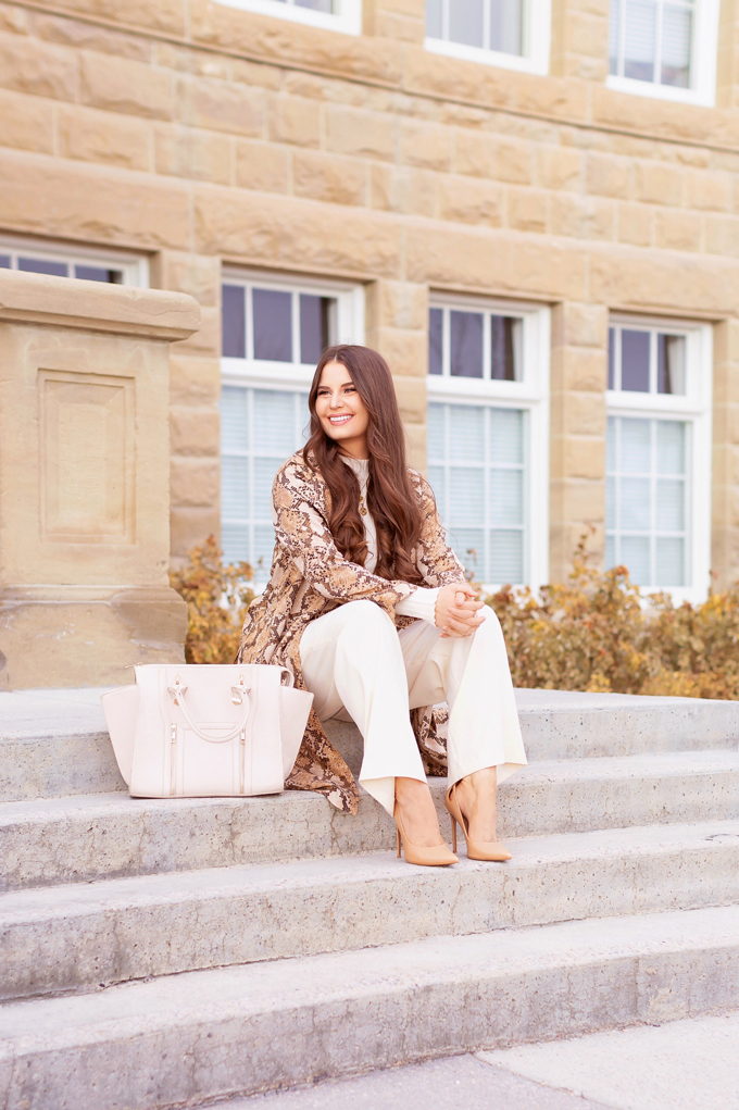 Autumn 2019 Lookbook: Snakeskin Chinook | Top Fall / Winter 2019 Trends | Top Autumn 2019 Trends and How to Wear Them | Brunette woman wearing a snakeskin trench coat with cream paperboy wide leg pants, a cream ribbed turtleneck, an oversized cream tote bag and cream cat eye sunglasses | Professional Fall / Winter 2019 Outfit Ideas | How to Style Snakeskin for the Office | What to Wear during a Chinook | Top Calgary Fashion & Creative Lifestyle Blogger // JustineCelina.com