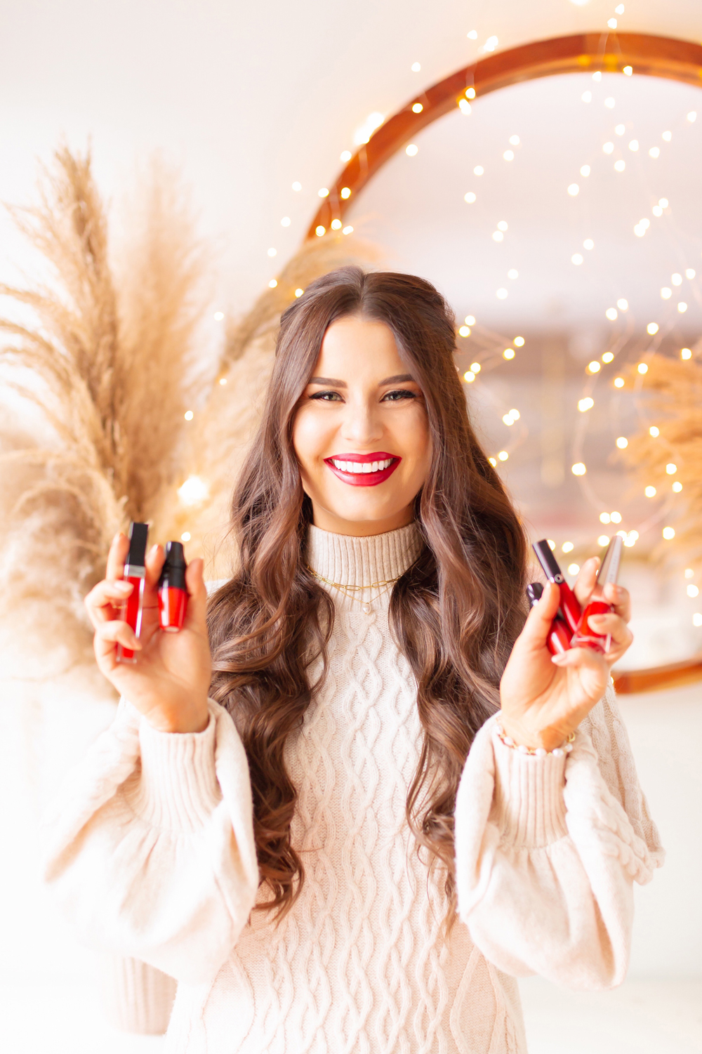 My Top 5 Red Lipsticks for the Holidays | The Best Luxury Lipsticks for Christmas 2021 photos, review, swatches | Brunette woman wearing a red lipstick and cable kit sweater dress in a festive holiday setting with bokeh lights | Best universal red lipstick | Best luxury red lipstick | Best red liquid lipstick | Best long lasting red lipstick | Best red lipstick 2021 | Christmas lipstick 2021 | Mask friendly red lipstick | Calgary Beauty Blogger // JustineCelina.com