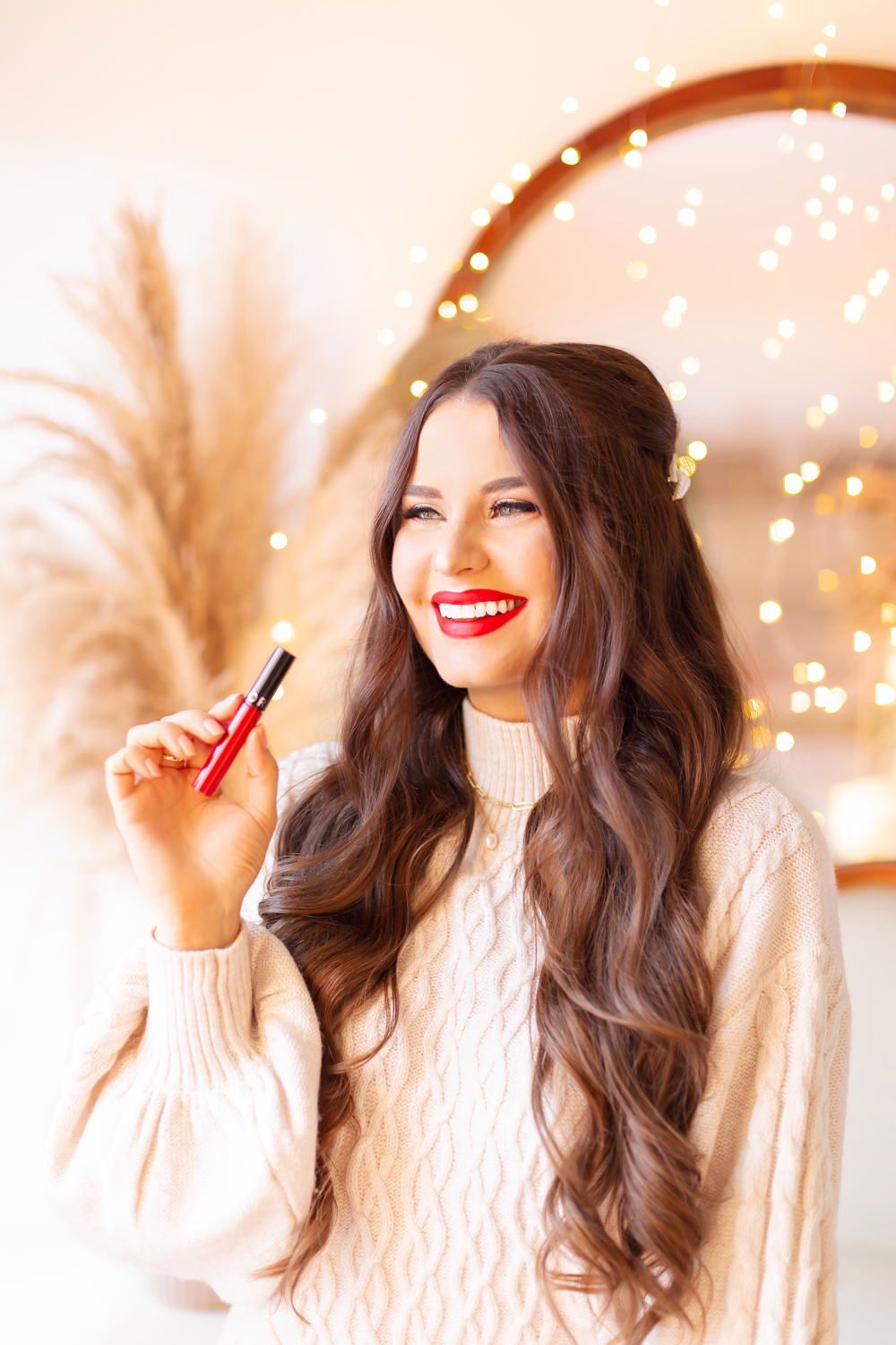 My Top 5 Red Lipsticks for the Holidays | SEPHORA COLLECTION Cream Lip Stain in 01 Always Red photos, review, swatches | Brunette woman wearing a red lipstick and cable kit sweater dress in a festive holiday setting with bokeh lights | Best universal red lipstick | Best luxury red lipstick | Best red liquid lipstick | Best long lasting red lipstick | Best red lipstick 2021 | Christmas lipstick 2021 | Calgary Beauty Blogger | Calgary Beauty Blogger // JustineCelina.com