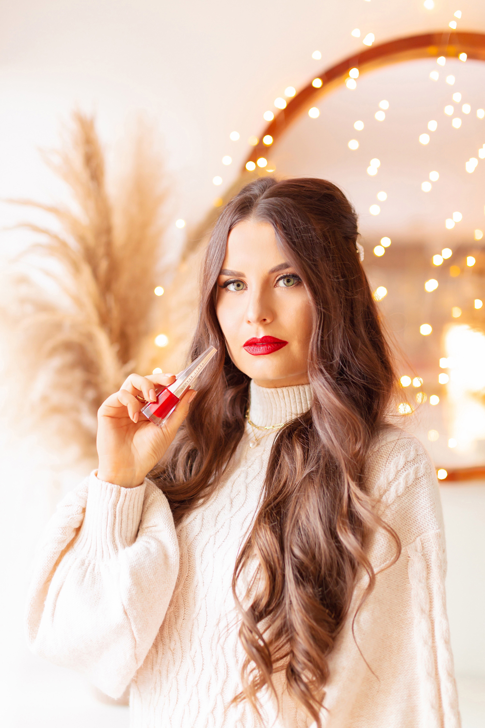 My Top 5 Red Lipsticks for the Holidays | FENTY BEAUTY by Rihanna Stunna Lip Paint Longwear Fluid Lip Color in Uncensored photos, review, swatches | Brunette woman wearing a red lipstick and cable kit sweater dress in a festive holiday setting with bokeh lights | Best universal red lipstick | Best luxury red lipstick | Best red liquid lipstick | Best long lasting red lipstick | Best red lipstick 2021 | Christmas lipstick 2021 | Calgary Beauty Blogger | Calgary Beauty Blogger // JustineCelina.com