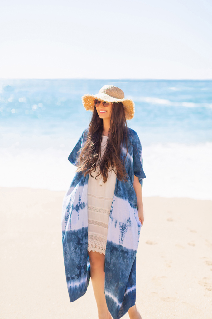 Resort 2020 Lookbook | Tropical Vacation Outfit Ideas | Cute Beach Vacation Outfits 2020 | Mexico Vacation Outfits | What to Wear on Vacation 2020 | How to Style Tie Dye | Tie Dye Outfit Ideas | The Best Beach Dresses & Coverups | Pantone 2020 Color of the Year Classic Blue Tie Dye Kimono | Brunette Woman wearing a white bikini cover-up, tie dye kimono and frayed brim straw hat | Camino Real Zaashila, Huatulco 2020 Review | Tangolunda Bay | Calgary Fashion & Travel Blogger // JustineCelina.com 