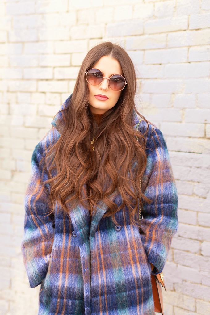 Colour Crush: Classic Blue | Brunette woman wearing a Classic Blue UO Oversized Plaid Wool Overcoat, Zara Straight Leg Blue Jeans, Mango Cognac Asymmetric Stiletto Shoes, H&M Brown Knit Turtleneck Sweater, TopShop Croc Embossed Crossbody Bag and Brown Circular Sunglasses in an urban Setting | How to Wear Pantone’s 2020 Color of the Year, Classic Blue | Pantone Color of The Year 2020 Fashion | Transitional Winter to Spring Fashion for Canadians | Calgary Fashion Blogger // JustineCelina.com