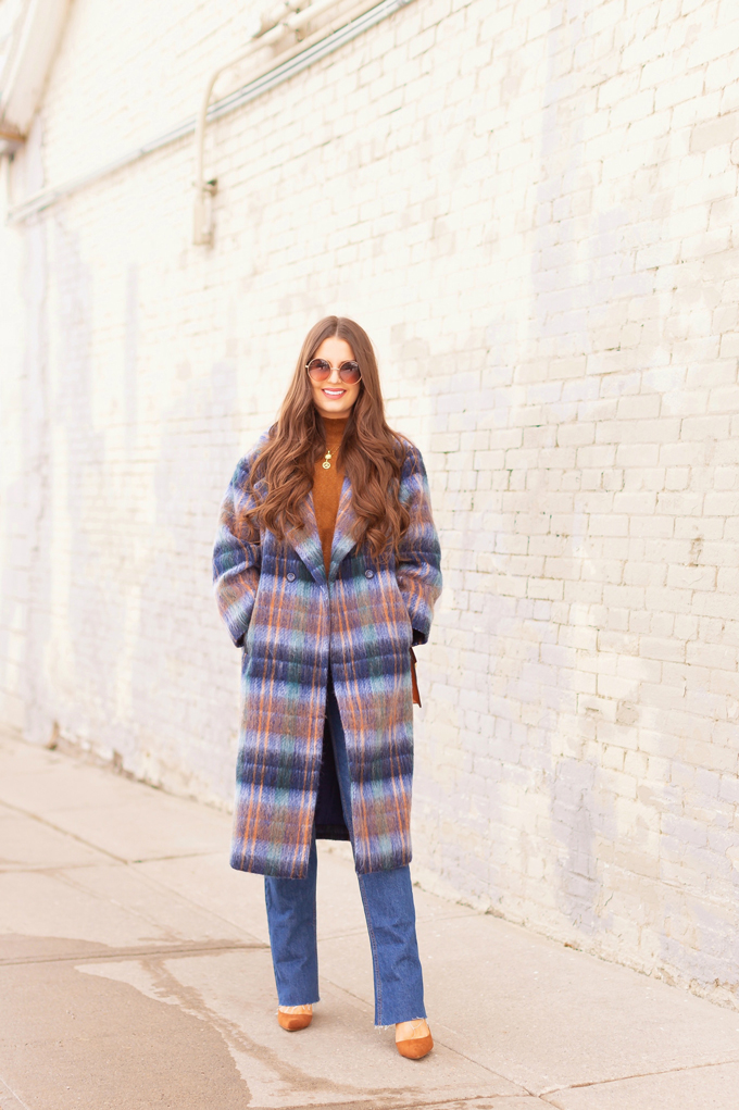 Colour Crush: Classic Blue | Brunette woman wearing a Classic Blue UO Oversized Plaid Wool Overcoat, Zara Straight Leg Blue Jeans, Mango Cognac Asymmetric Stiletto Shoes, H&M Brown Knit Turtleneck Sweater, TopShop Croc Embossed Crossbody Bag and Brown Circular Sunglasses in an urban Setting | How to Wear Pantone’s 2020 Color of the Year, Classic Blue | Pantone Color of The Year 2020 Fashion | Transitional Winter to Spring Fashion for Canadians | Calgary Fashion Blogger // JustineCelina.com