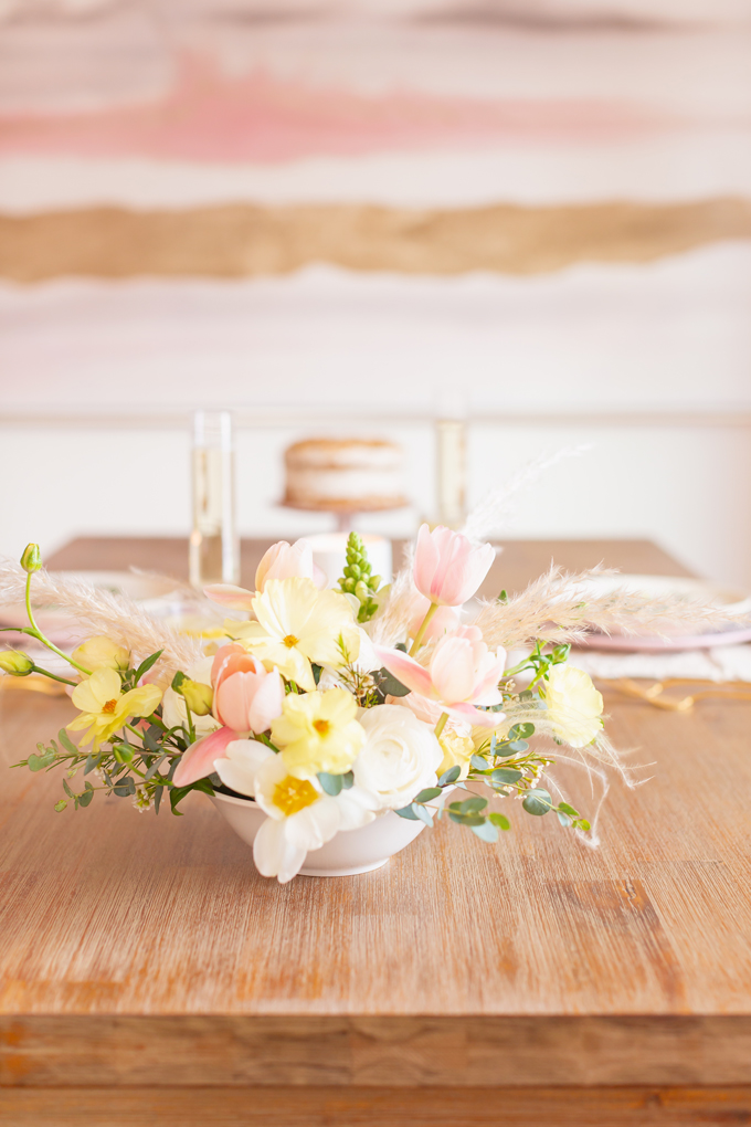 A Simple Easter Dinner for Two | JustineCelina’s Mid Century Modern Bohemian Dining Room Set for Easter | Easter Table Setting with a Mini Egg Birds Nest on Each Place Setting, Pastel Dinnerware, Champagne Flutes, Lemon Water, Gold Flatware, a Candle and Macrame Table Runner | Easter 2020 | Easter Entertaining at Home | Easter Floral Centrepieces | Easy Easter Decor Ideas | Mid Century Modern Easter Decor | Easy Easter Table Settings | Calgary Lifestyle and Decor Blogger // JustineCelina.com