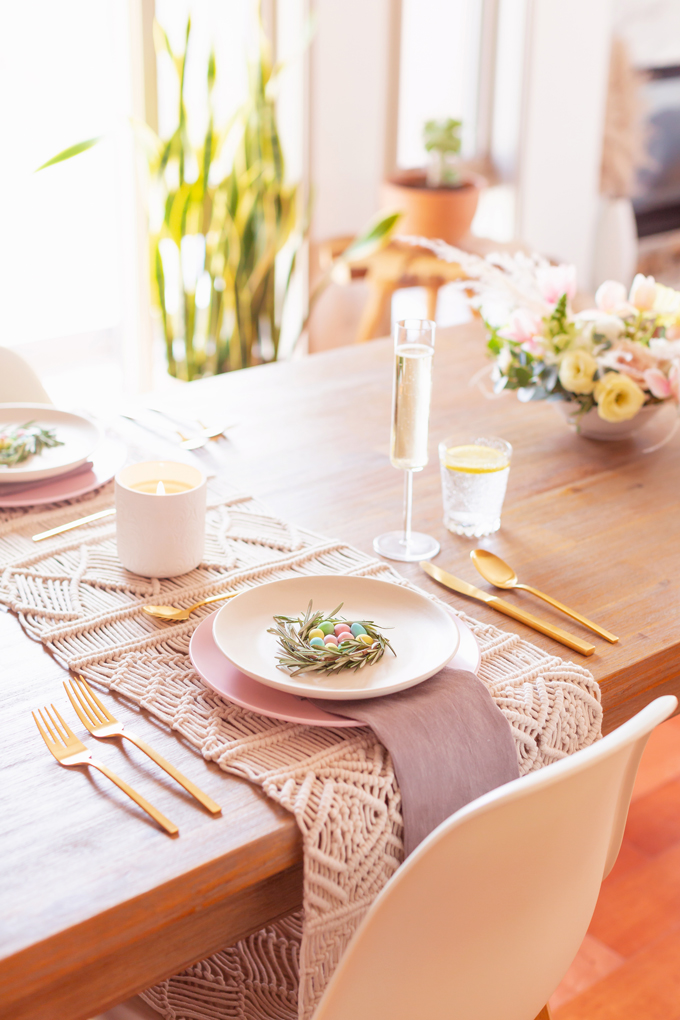 A Simple Easter Dinner for Two | JustineCelina’s Mid Century Modern Bohemian Dining Room Set for Easter | Easter Table Setting with a Mini Egg Birds Nest on Each Place Setting, Pastel Dinnerware, Champagne Flutes, Lemon Water, Gold Flatware, a Candle and Macrame Table Runner | Easter 2020 | Easter Entertaining at Home | Easter Floral Centrepieces | Easy Easter Decor Ideas | Mid Century Modern Easter Decor | Easy Easter Table Settings | Calgary Lifestyle and Decor Blogger // JustineCelina.com