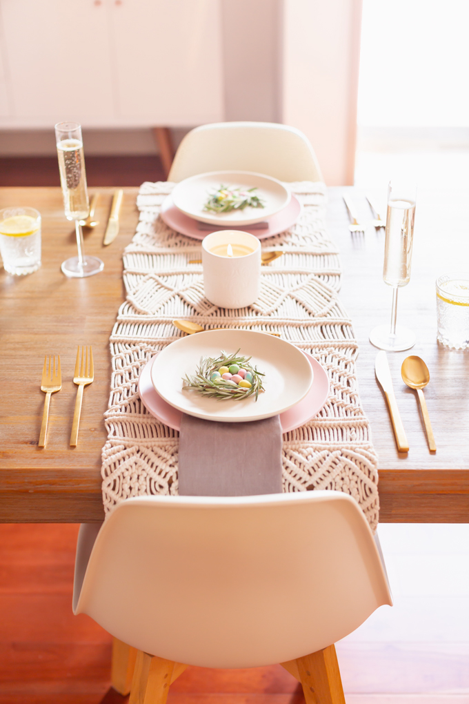 A Simple Easter Dinner for Two | JustineCelina’s Mid Century Modern Bohemian Dining Room Set for Easter | Easter Table Setting with a Mini Egg Birds Nest on Each Place Setting, Pastel Dinnerware, Champagne Flutes, Lemon Water, Gold Flatware, a Candle and Macrame Table Runner | Easter 2020 | Easter Entertaining at Home | Easter Floral Centrepieces | Easy Easter Decor Ideas | Mid Century Modern Easter Decor | Easy Easter Table Settings | Calgary Lifestyle and Decor Blogger // JustineCelina.com