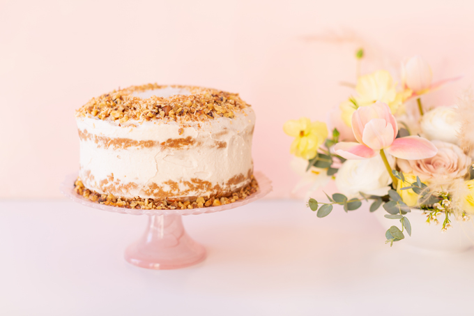 A Simple Easter Dinner for Two | Easter Vegan, Gluten and Oil Free Carrot Cake on a blush cakestand | Easter 2020 | Easter Entertaining at Home | Healthy Easter Carrot Cake | Easter Flowers | Easter Floral Centrepieces | Fresh Spring Flowers | Calgary Lifestyle and Decor Blogger // JustineCelina.com