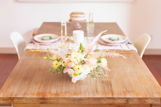 A Simple Easter Dinner for Two | JustineCelina’s Mid Century Modern Bohemian Dining Room Set for Easter | Easter Table Setting with a Mini Egg Birds Nest on Each Place Setting, Pastel Dinnerware, Champagne Flutes, Lemon Water, Gold Flatware, a Candle and Macrame Table Runner | Easter 2020 | Easter Entertaining at Home | Easter Floral Centrepieces | Easy Easter Decor Ideas | Mid Century Modern Easter Decor | Easy Easter Table Settings | Calgary Lifestyle and Decor Blogger // JustineCelina.com