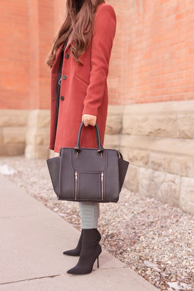 WINTER / SPRING 2020 LOOKBOOK | Boss Babe | Brunette woman wearing a Vero Moda Rust Dress Coat, H&M Houndstooth Paperbag Pants, Black Saks 5th Avenue Cashmere Turtleneck, Lulus Back Wing Woman Handbag and Zara Black Sock Boots | Professional Winter to Spring Outfit Ideas | Top Transitional Winter to Spring 2020 Trends | Canadian Winter / Spring Lookbook | How to Wear Spring 2020’s Mini Dress | Transitional Winter to Spring Fashion for Canadians // JustineCelina.com