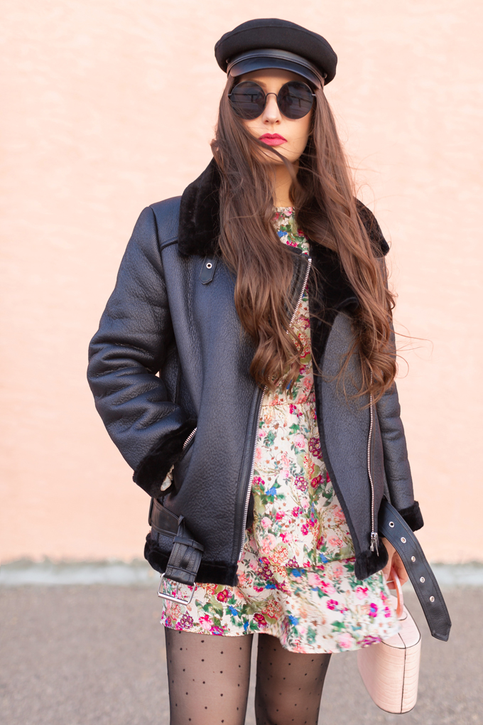 WINTER / SPRING 2020 LOOKBOOK | Rebel Florals | Brunette woman wearing a Zara Full Sleeve Print Dress with a Faux Fur Lined Black Biker Jacket, Black Faux Leather Brimmed Baker Boy Hat, Blush Croc Embossed Bag | Black Circular Sunglasses, Sheer Polka Dot Tights an H&M Black Faux Suede Knee-high Boots | Top Transitional Winter to Spring 2020 Trends | Canadian Winter / Spring Lookbook | How to Wear Spring 2020’s Mini Dress | Transitional Winter to Spring Fashion for Canadians // JustineCelina.com