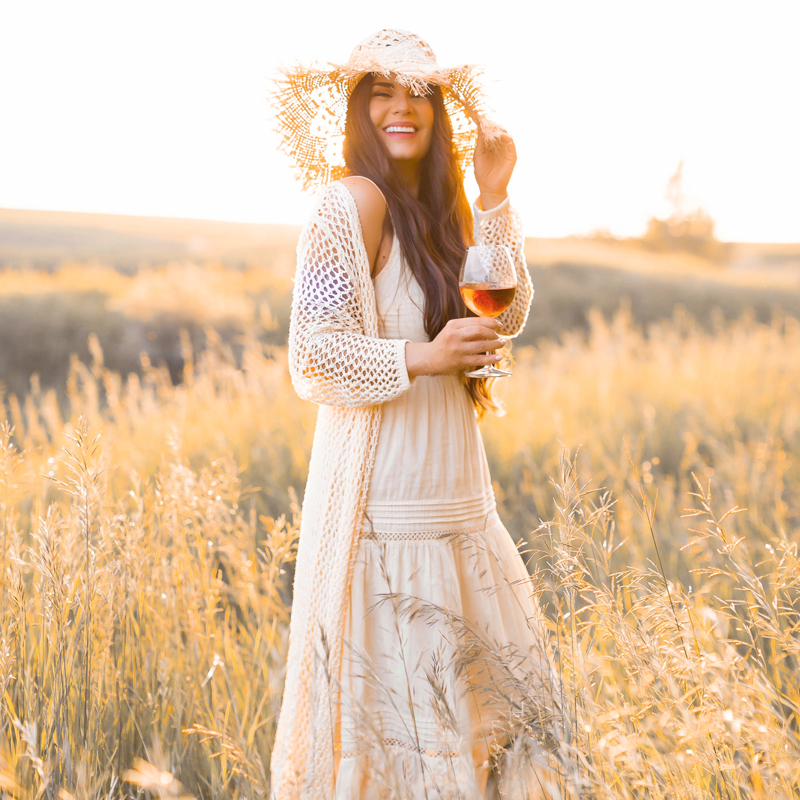 June 2020 Soundtrack | Chill Summer Playlist | Inspiring Summer Playlist Spotify | Laughing brunette woman enjoying a glass of rosé wine in a sunlit prairie wheat field at sunset | JustineCelina’s childhood home in Wheatland County, Alberta | Summer 2020 Bohemian Style Ideas | Boho Casual Summer Dresses | Summer 2020 Fashion | Best H&M Dresses Summer 2020 | How to Style a Frayed Brim Straw Hat | Calgary, Alberta, Canada Creative Lifestyle Blogger and Entrepreneur// JustineCelina.com