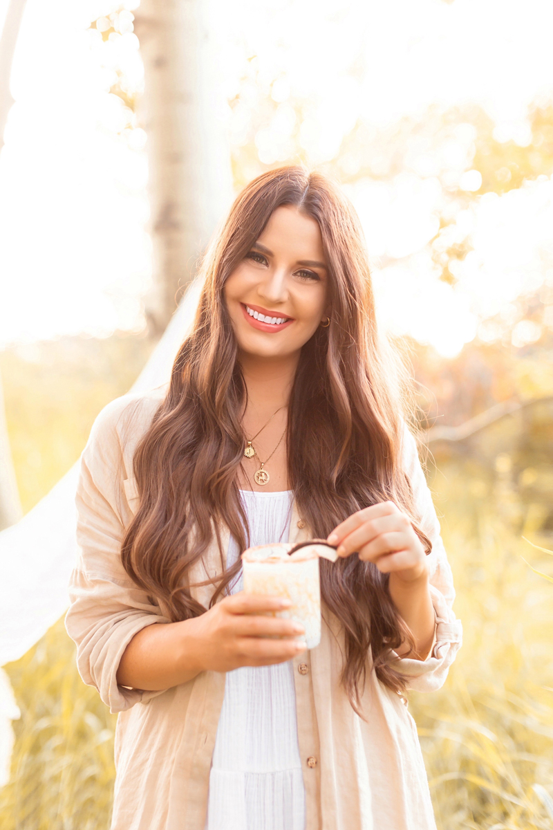 Creamy Coconut Mango Mezcalritas | Mango Margarita | Coconut Mango Margarita | Smoky Mezcal Cocktails | Mango Mezcal Margarita | Tajín Salted Rim | Mezcalerita Drink | Best Mezcal Oaxaca | Mezcal Margarita Recipe | Simple Mezcal Cocktails | Vegan Mezcal Cocktail | Oaxacan Mezcalrita Recipe | Smiling brunette woman wearing a white dress, linen shirt and sunglasses enjoying a mezcalrita | Calgary Cocktail Photographer and Stylist | Calgary Lifestyle, Food and Cocktail Blogger // JustineCelina.com