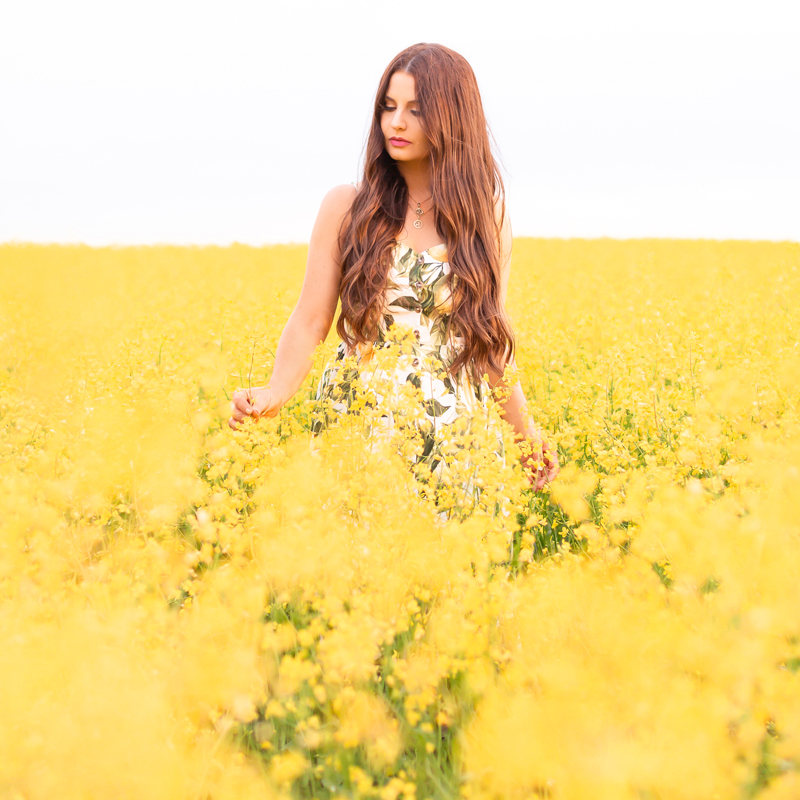 July 2020 Soundtrack | Chill Summer Playlist | Inspiring Summer Playlist Spotify | Dreamy Summer 2020 Playlist | Brunette woman in a field of canola at sunset wearing a lemon print sundress | Yellow Flower Field | Wheatland County, Alberta, Canada Canola Field | Summer 2020 Bohemian Style Ideas | Boho Casual Summer Dresses | Summer 2020 Fashion | Best H&M Dresses Summer 2020 | Alberta Canola Fields 2020 | Calgary, Alberta, Canada Creative Lifestyle Blogger and Entrepreneur// JustineCelina.com