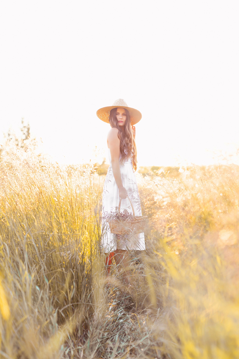 Summer 2020 Lookbook | Boho Summer 2020 Outfit Ideas | Summer Capsule Wardrobe | Summer Quarantine Outfits | Classic Summer Outfit Ideas | The Best Linen Dresses 2020 | The Best Little White Dresses 2020 | Classic Linen Sundress | Summer Outfit Ideas | Classic Affordable Summer Style | Summer 2020 Trends | Brunette woman wearing H&M’s Linen-Blend Dress in White with a Straw Hat in a Picking Wheat holding a Wicker Basket at Golden Hour | Calgary Alberta Fashion Blogger // JustineCelina.com