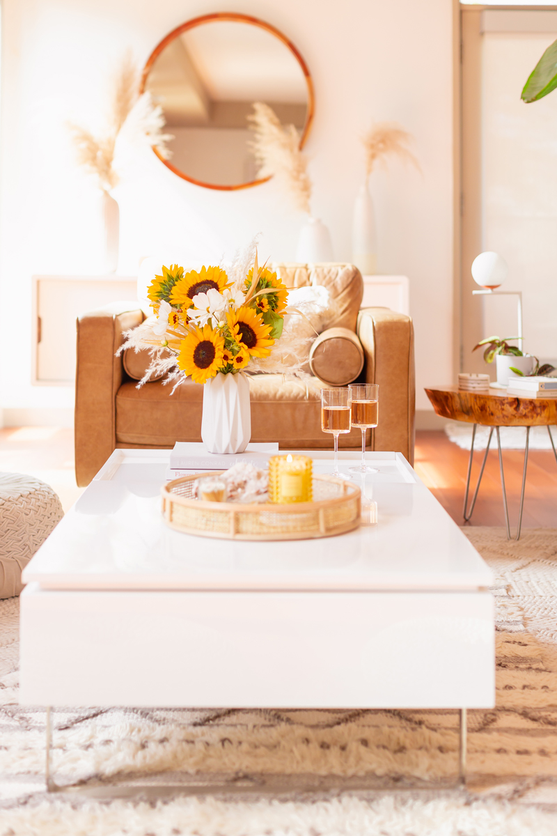 Our Transitional Summer Meets Autumn Decor | Summer to Fall Decor | September Decorations | Sunflower Decor | Easy Fall Decorating Ideas 2020 | Affordable Fall Decor | Simple Fall Decor Ideas | Fall Apartment Decor JustineCelina’s Inner City Calgary bohemian, mid-century modern Living Room | Cheerful Sunflower Arrangement with white Cosmos and Pampas Grass on a coffee table with 2 glasses of rosé | Summer Meets Autumn Decor | Sunflower Decor Ideas | Calgary Lifestyle Blogger // JustineCelina.com