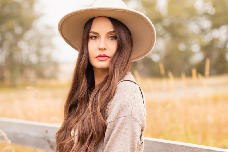 Early Autumn 2020 Lookbook | Country Checks | Brunette woman wearing a taupe flat brimmed hat and taupe cardigan next to an weathered fence in the prairies | Boho Fall 2020 Outfit Ideas | Top Fall 2020 Trends | How to Style Midi Dresses for Fall | Bohemian Fall outfit Ideas | How to Wear Florals in Fall | The Best Fedoras 2020 | How to Style a Flat Brim Hat | Cottagecore Fall Outfit Ideas | Calgary Alberta Fashion & Lifestyle Blogger // JustineCelina.com