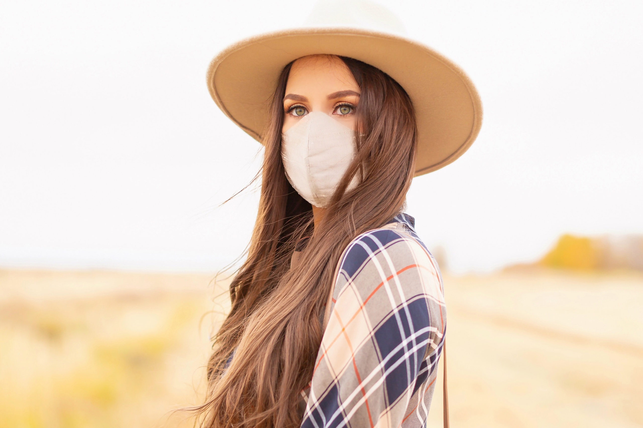 Early Autumn 2020 Lookbook | Country Checks | Brunette woman wearing a taupe flat brimmed fedora, a taupe, orange and navy blue plaid dress and a tan duponi silk non-medical face mask | Boho Fall 2020 Outfit Ideas | Top Fall 2020 Trends | Thanksgiving Outfit Idea | Bohemian Fall outfit | Plaid Outfit Ideas | The Best Non-Medical Silk Face Masks | How to coordinate your face mask to your outfit | Cottagecore Fall Outfit Ideas | Calgary Alberta Fashion & Lifestyle Blogger // JustineCelina.com