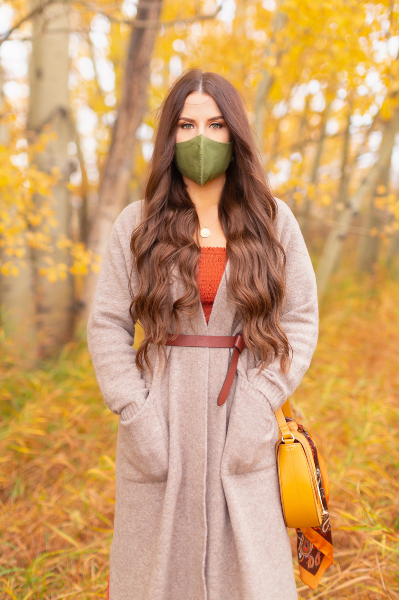 Early Autumn 2020 Lookbook | Cozy Coatigan | Brunette woman wearing a beige coatigan, cognac tie-detail belt, rust smocked peasant sleeve dress and an olive green linen non-medical face mask during the fall | Top Fall 2020 Trends | Boho Fall 2020 Outfit Ideas | Top Fall 2020 Trends | How to Style a Coatigan | The Best Non-Medical Linen Face Masks | Bohemian Fall outfit Ideas | Cottagecore Fall Outfit Ideas | Calgary Alberta Fashion & Lifestyle Blogger // JustineCelina.com