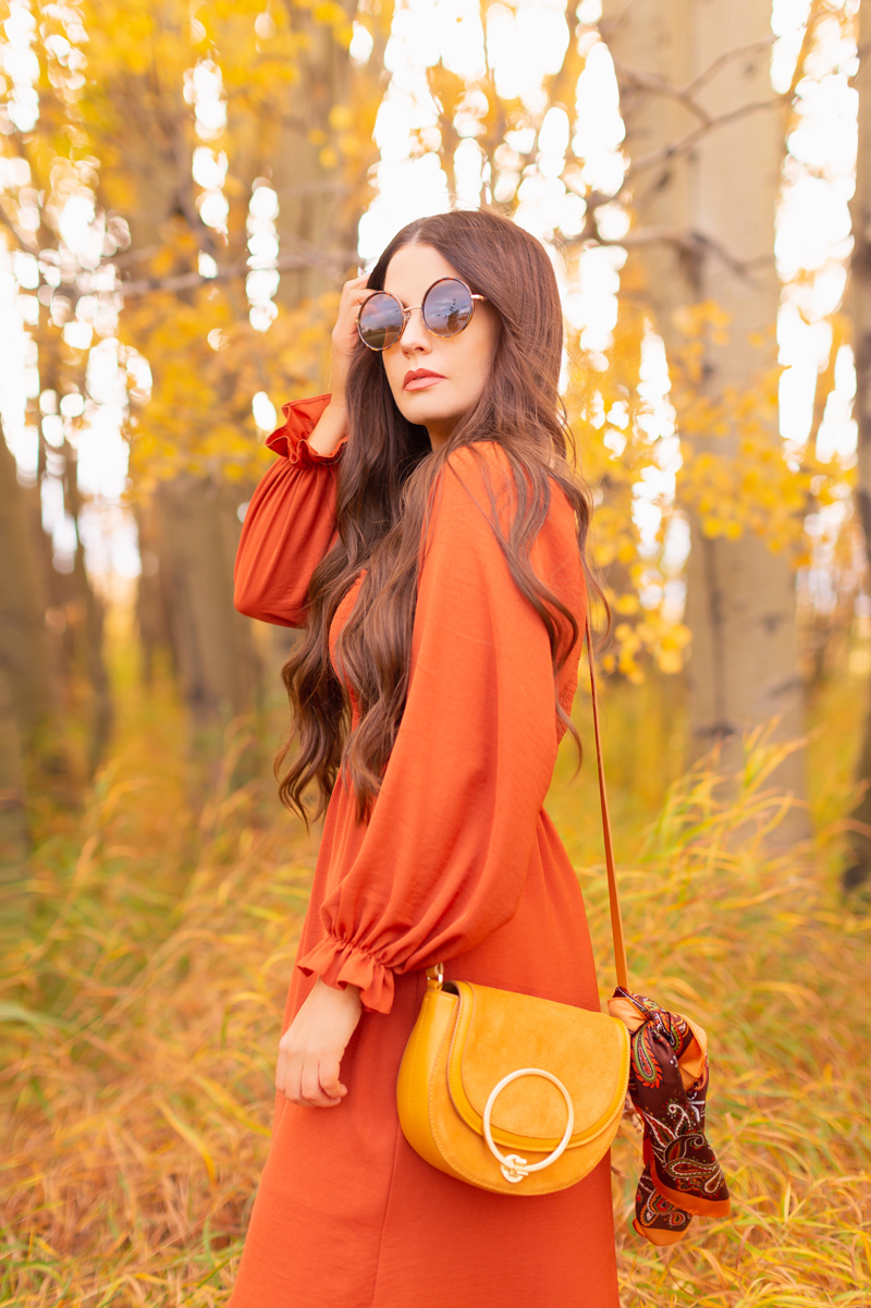 Early Autumn 2020 Lookbook | Cozy Coatigan | Brunette woman wearing round tortoise sunglasses, a rust smocked peasant sleeve dress and mustard crossbody saddle bag with a vintage paisley scarf tied around the strap against beautiful fall foliage | Top Fall 2020 Trends | Boho Fall 2020 Outfit Ideas | Top Fall 2020 Trends | How to Style a Coatigan | The Best Coatigans | Bohemian Fall outfit Ideas | Cottagecore Fall Outfit Ideas | Calgary Alberta Fashion & Lifestyle Blogger // JustineCelina.com