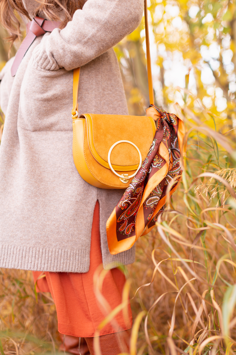 Early Autumn 2020 Lookbook | Cozy Coatigan | Brunette woman wearing a beige coatigan, cognac tie-detail belt, rust smocked dress and mustard crossbody saddle bag and cognac leather knee-high boots during the fall | Top Fall 2020 Trends | Boho Fall 2020 Outfit Ideas | Top Fall 2020 Trends | How to Style a Coatigan | The Best Coatigans | Bohemian Fall outfit Ideas | Cottagecore Fall Outfit Ideas | Calgary Alberta Fashion & Lifestyle Blogger // JustineCelina.com