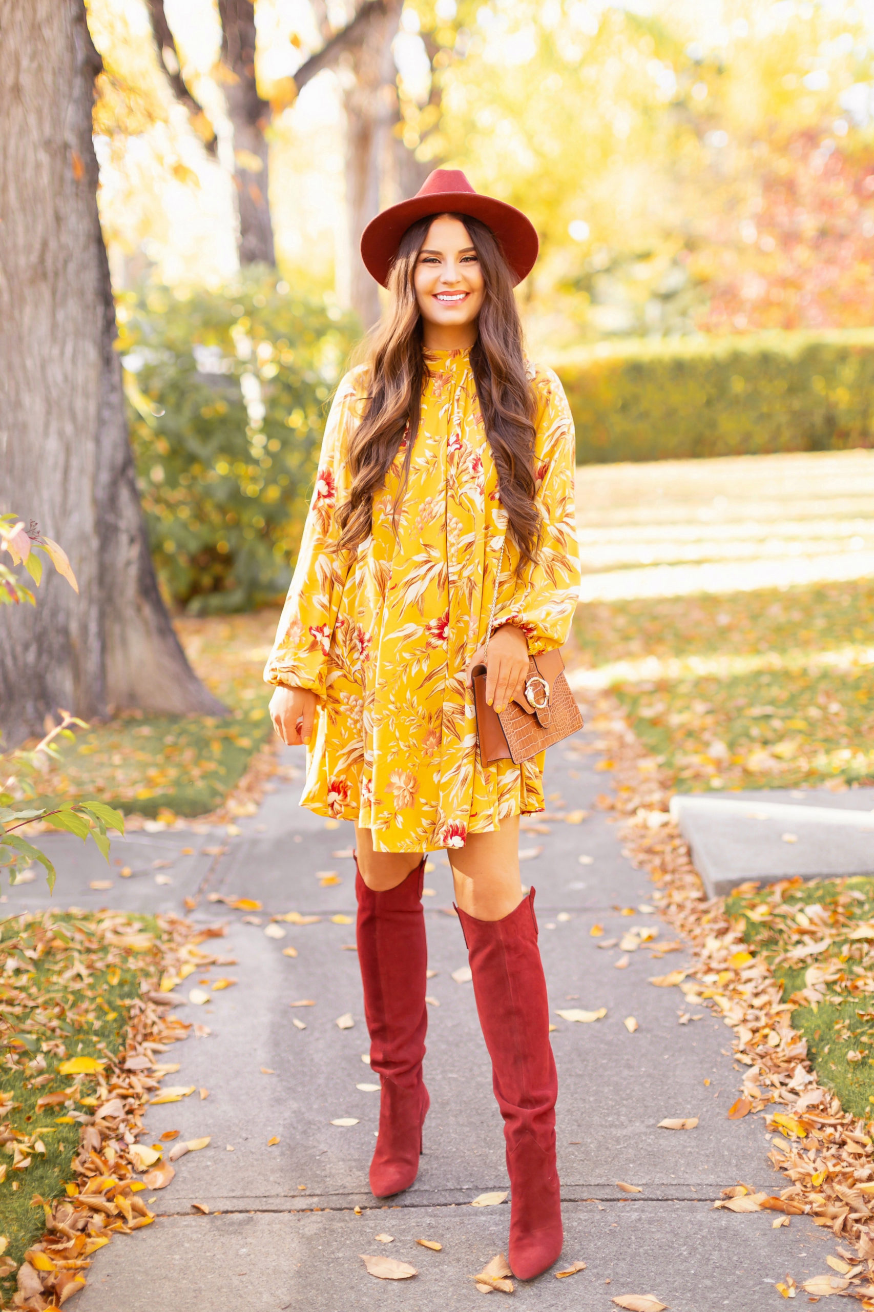 Early Autumn 2020 Lookbook | Mindful Mustard | Smiling brunette woman wearing a rust fedora, a mustard yellow botanical print shift dress, rust knee high western boots and a cognac croc-embossed bag on a sunny autumn afternoon | warm weather fall outfit ideas | Fall 2020 Trend Guide | Casual Fall Fashion | Boho Fall 2020 Outfit Ideas | Fall in Calgary | | Transitional Summer Meets Autumn Fashion | Fall Photoshoot | Calgary Alberta Fashion & Lifestyle Blogger // JustineCelina.com