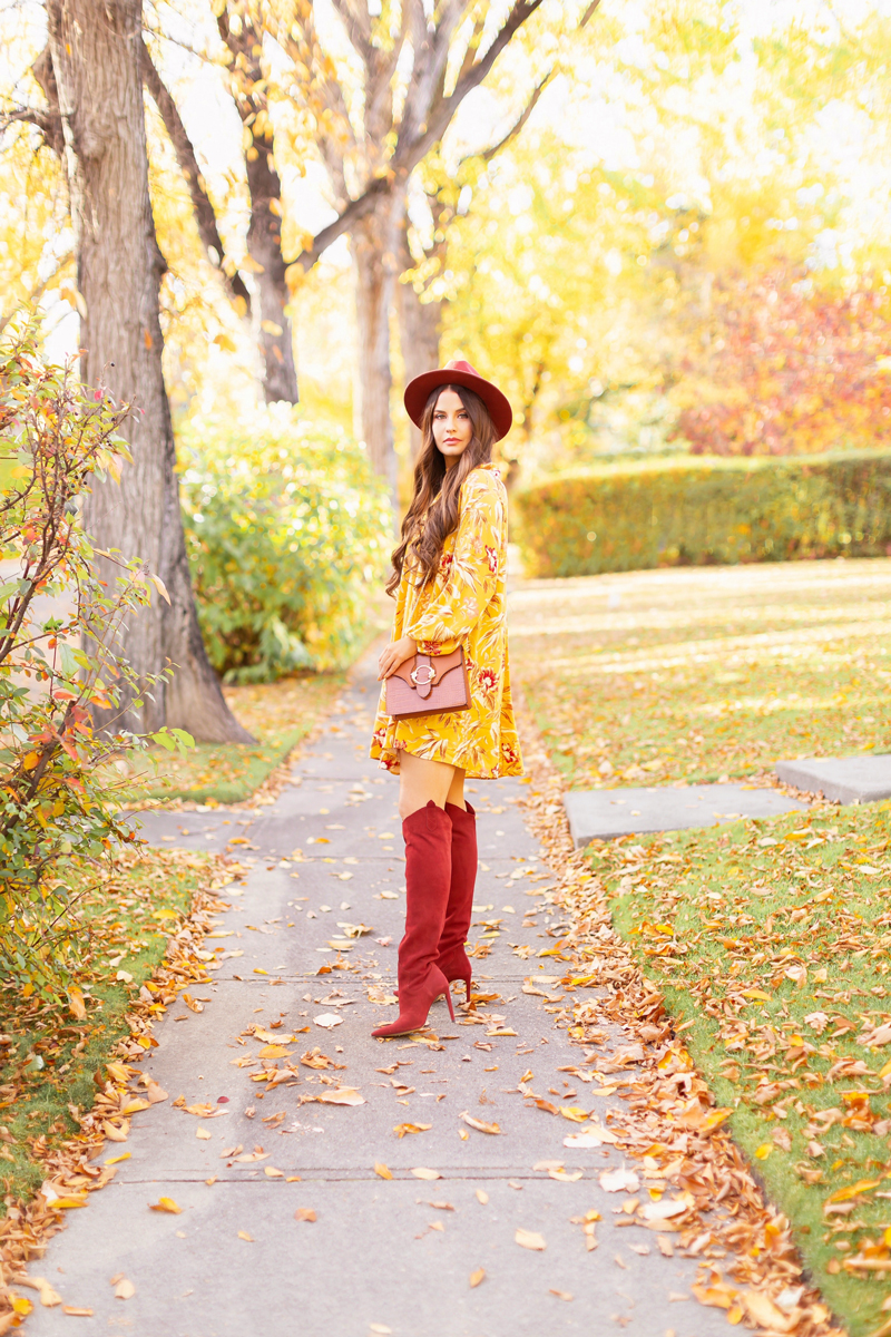 Early Autumn 2020 Lookbook | Mindful Mustard | Brunette woman wearing a rust fedora, a mustard yellow botanical print shift dress, rust knee high western boots and a cognac croc-embossed bag on a sunny autumn afternoon | warm weather fall outfit ideas | Fall 2020 Trend Guide | Casual Fall Fashion | Boho Fall 2020 Outfit Ideas | Fall in Calgary | Transitional Summer Meets Autumn Fashion | Fall Photoshoo Ideas | Calgary Alberta Fashion & Lifestyle Blogger // JustineCelina.com
