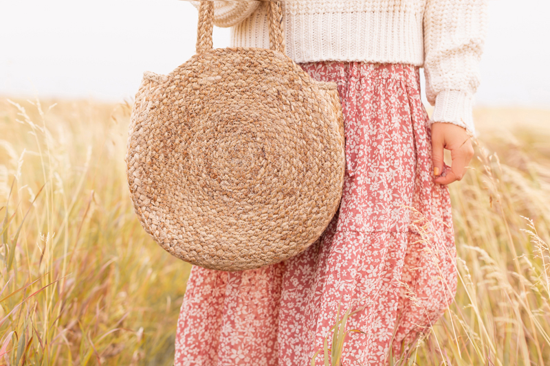 Early Autumn 2020 Lookbook | Prairie Chic | Brunette woman wearing a rose floral midi dress, a chunky cream knit and a round jute bag in a wheat field | Boho Fall 2020 Outfit Ideas | Boho Fall 2020 Outfit Ideas | Top Fall 2020 Trends | Fall on the Alberta Prairies | Thanksgiving Outfit Idea | Bohemian Fall outfit Ideas | The Best H&M Knitwear | Cottagecore Fall Outfit Ideas | How to Style Summer Dresses Into Fall Calgary Alberta Fashion & Lifestyle Blogger // JustineCelina.com