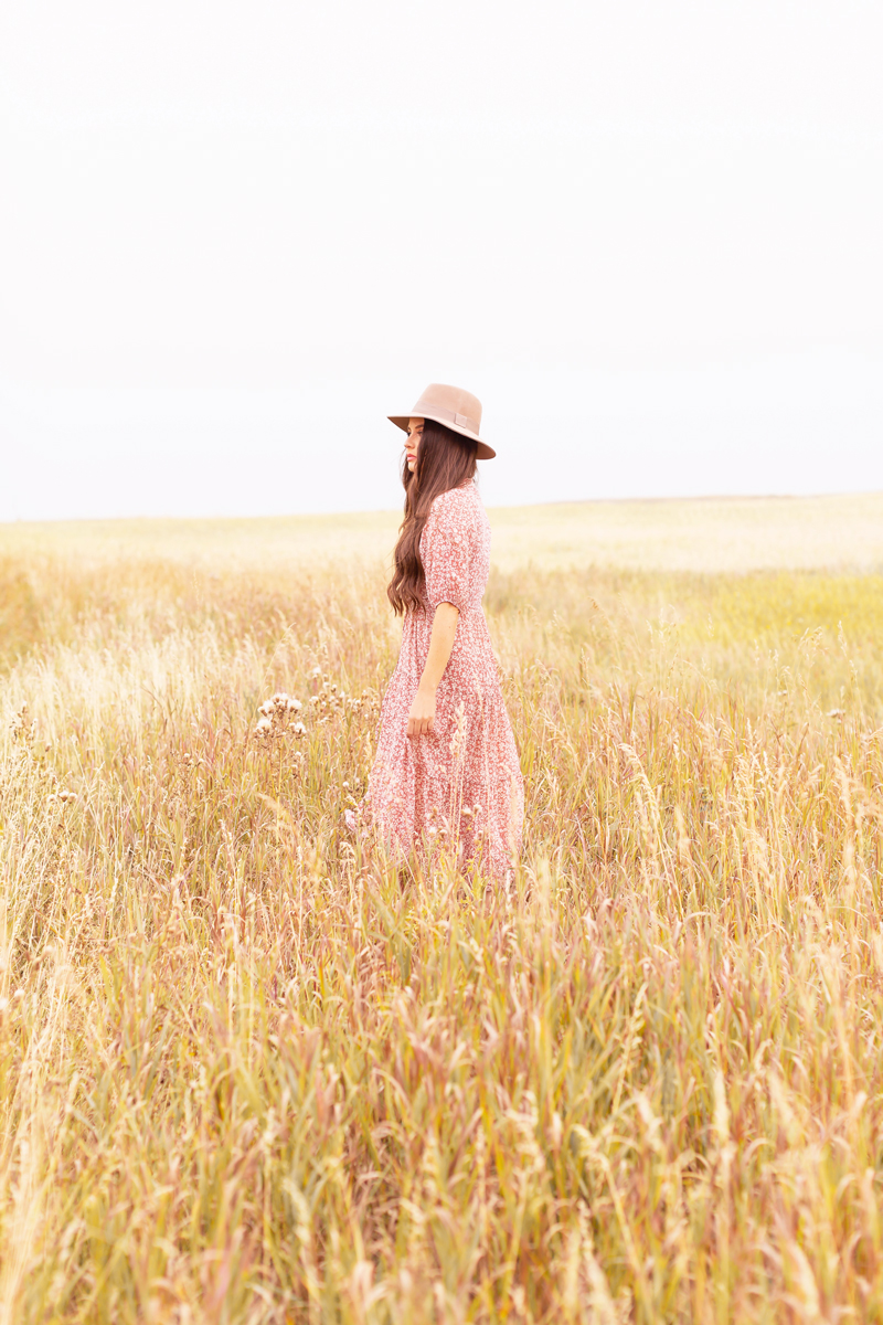 Early Autumn 2020 Lookbook | Prairie Chic | Brunette woman wearing a rose floral midi dress, a tan felt fedora and a round jute bag in a wheat field | Boho Fall 2020 Outfit Ideas | Top Fall 2020 Trends | Fall on the Alberta Prairies | Thanksgiving Outfit Idea | Bohemian Fall outfit Ideas | The Best H&M Knitwear | The Best New Look Chiffon Dresses | Cottagecore Fall Outfit Ideas | How to Style Summer Dresses Into Fall Calgary Alberta Fashion & Lifestyle Blogger // JustineCelina.com