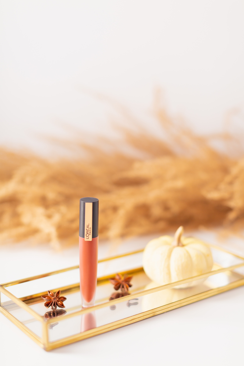 My Top 5 Pumpkin Spice Lipsticks | JustineCelina’s favourite fall lipsticks | The Best Pumpkin Spice Lipsticks for Fall | Fall 2020 Lipstick Trends |  L'Oreal Rouge Signature Liquid Lip Colour in I Amaze Photos, Review, Swatches | Light / Medium Skintone | The Best Drugstore Fall Lipsticks | The Best Pumpkin Spice Lipsticks for Fall | Lipstick on a Mirrored Tray with spices, a white mini pumpkin and pampas grass in the background | Calgary Beauty Blogger // JustineCelina.com