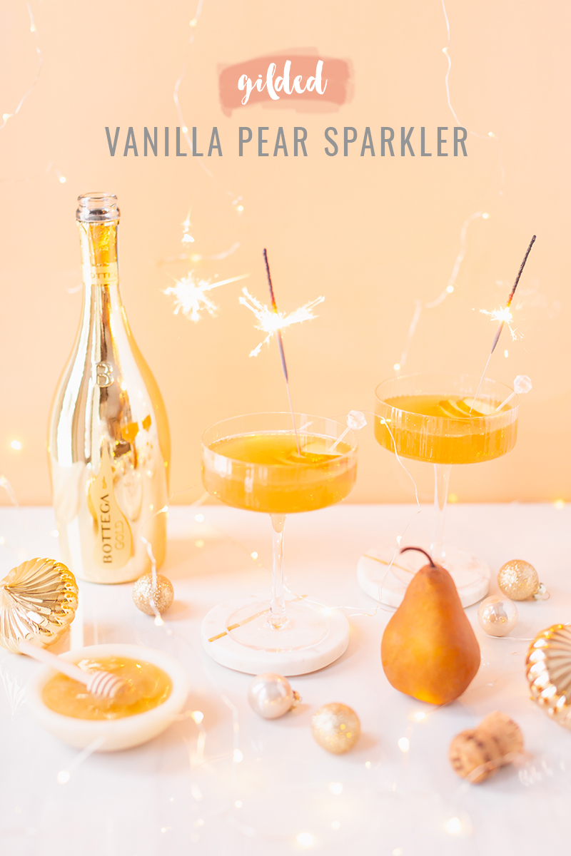 Gilded Vanilla Pear Sparkler | A glitzy, French 75 inspired New Years Eve cocktail featuring 24 karat gold infused gin, Brut Prosecco, Italian vanilla liqueur, lemon juice and Honeyed Vanilla Pear Syrup | Best NYE 2020 cocktails | How to Make sparkling NYE cocktails at home | Champagne cocktail recipe | Champagne Christmas drinks | New Years Eve Sparklers | Modern Refined Sugar Free French 75 | NYE Cocktail Party Recipes | Calgary Creative Lifestyle & Cocktail Blogger // JustineCelina.com