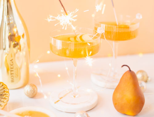 Gilded Vanilla Pear Sparkler | A glitzy, French 75 inspired New Years Eve cocktail featuring 24 karat gold infused gin, Brut Prosecco, Italian vanilla liqueur, lemon juice and Honeyed Vanilla Pear Syrup | Best NYE 2020 cocktails | How to Make sparkling NYE cocktails at home | Champagne cocktail recipe | Champagne Christmas drinks | New Years Eve Sparklers | Modern Refined Sugar Free French 75 | NYE Cocktail Party Recipes | Calgary Creative Lifestyle & Cocktail Blogger // JustineCelina.com