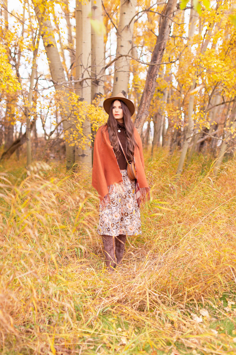 Fall 2020 Lookbook | A Lesson in Layering | Brunette woman wearing a fall floral midi dress, a brown turtleneck, a burnt orange shawl, brown western boots, a brown fedora and a round cognac crossbody bag amongst fall leaves | Boho Fall 2020 Outfit Ideas | Top Fall / Winter 2020 Trends | Bohemian Fall / Winter outfit Ideas | Cottagecore Fall / Winter Outfit Ideas | How to Style Midi Dresses into Fall and Winter | Creative Layering Ideas | Calgary Alberta Fashion Blogger // JustineCelina.com