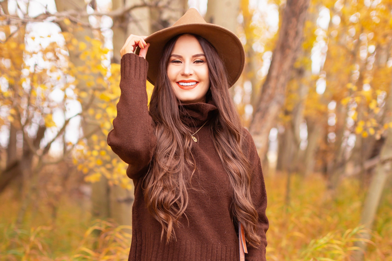 Fall 2020 Lookbook | A Lesson in Layering | Brunette woman wearing a fall floral midi dress, a brown turtleneck, brown western boots, a brown fedora and a round cognac crossbody bag amongst fall leaves | Boho Fall 2020 Outfit Ideas | Top Fall / Winter 2020 Trends | Bohemian Fall / Winter outfit Ideas | Cottagecore Fall / Winter Outfit Ideas | How to Style Midi Dresses into Fall and Winter | Creative Layering Ideas | How to Mix Prints | Calgary Alberta Fashion Blogger // JustineCelina.com