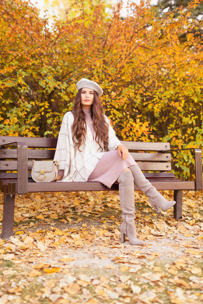 Fall 2020 Lookbook | Ruana Revival | Brunette woman sitting on a park bench surrounded by fall leaves, wearing a cream ruana poncho, cotton blush sweater dress, grey beret, grey Chloe Tess bag, and grey knee high suede boots | Boho Fall 2020 Outfit Ideas | Fall in Calgary | How to Style a Poncho | Comfortable Fall / Winter Outfit Ideas | Timeless Fall Outfit Ideas | fallwinter 2020 2021 fashion trends | fall 2020 womens fashion trends | Calgary Alberta Fashion Blogger // JustineCelina.com