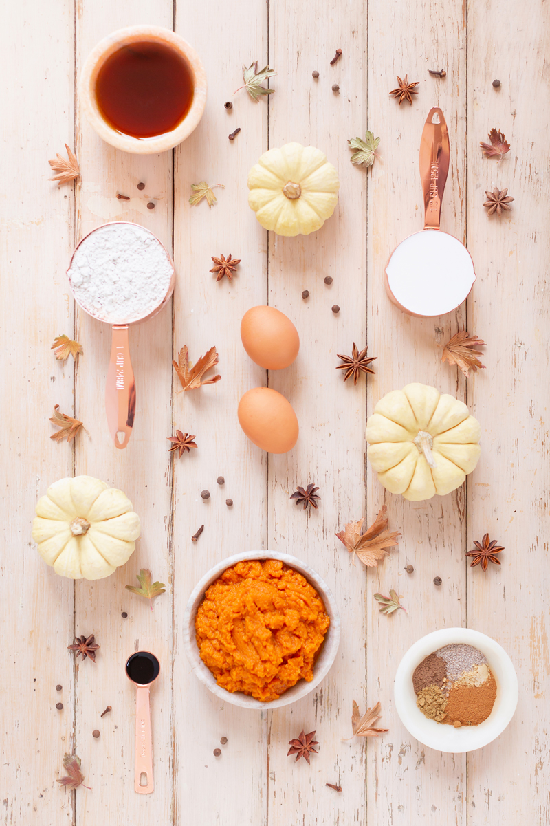 Gluten Free Mapled Pumpkin Chai Bread | Baking ingredients for a Dairy Free, Gluten Free, Refined Sugar Free, Oil Free Pumpkin Chai Spice Bread styled with spices and white mini pumpkins arranged on blush pink barn board backdrop | Easy Pumpkin Bread | Moist Pumpkin Bread | The Best Gluten Free Fall Baking Recipes | No Sugar Pumpkin Bread | Maple Syrup Pumpkin Bread | Pumpkin Bread Cake | Healthy Pumpkin Bread | Calgary Plant Based Food Blogger // JustineCelina.com