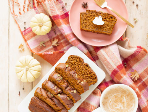 Gluten Free Mapled Pumpkin Chai Bread | Sliced Pumpkin Bread on a Marble Serving Board, served on 2 pink plates with gold forks and a chai latte | Chai Spice Bread styled with spices and white mini pumpkins arranged on blush pink barn board backdrop | Easy Pumpkin Bread | Moist Pumpkin Bread | The Best Gluten Free Fall Baking Recipes | No Sugar Pumpkin Bread | Maple Syrup Pumpkin Bread | Pumpkin Bread Cake | Healthy Pumpkin Bread | Calgary Plant Based Food Blogger // JustineCelina.com