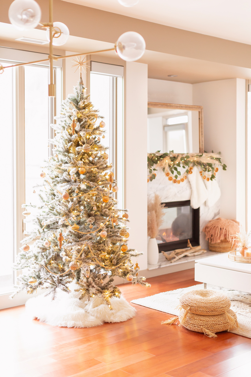 Mid Century Meets Boho Holiday Decor | Bright and airy Mid Century Modern Living Room with a Flocked Christmas Tree and Sputnik Metallic Tree Topper | Mid Century Modern Christmas Tree Skirt | Boho Christmas Decorating Ideas for Apartments | Flocked Christmas Tree with Wood Garland, Metallic and Wood Ornaments | Bohemian Holiday Home Tour 2020 | Boho Chic Christmas Decor | Glam neutral holiday decor | Pampas Grass Holiday Arrangement | Boho Christmas Tree // JustineCelina.com 