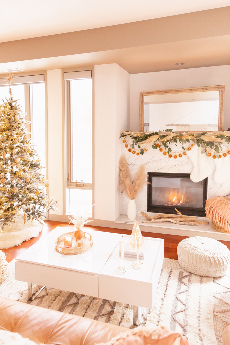 Mid Century Meets Boho Holiday Decor | Bright and airy Mid Century Modern Living Room with a Flocked Christmas Tree and Sputnik Metallic Tree Topper | Boho eucalyptus garland with pampas grass, fresh cedar, bleached Italian ruscus and a beaded dried orange garland | Boho Christmas Decorating Ideas for Apartments | Flocked Christmas Tree with Wood Garland and Boho Ornaments | Holiday Home Tour | Boho Chic Christmas Decor | Glam neutral holiday decor | Boho Christmas Tree // JustineCelina.com