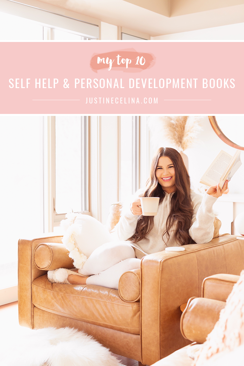 My Top 10 Self Help and Personal Development Books | Smiling brunette woman in cream loungewear sitting on a caramel leather chair reading a book in a bright boho living room | Best Self Help Books | Best Audible Books | Motivational Books | Inspirational Books | Inspirational Books for Women | Books for Female Entrepreneurs | Motivational Books for Creatives | Best Self Help Books for Women | Best Personal Growth Books | Self Healing Books | Calgary Lifestyle Blogger // JustineCelina.com
