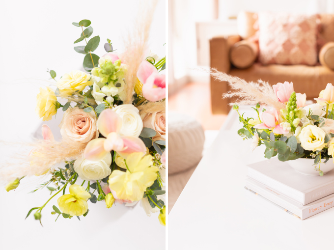 A cheerful spring flower arrangement with pampas grass on white coffee table with a pink mug in bright and airy boho living room | Calgary Lifestyle Blogger // JustineCelina.com