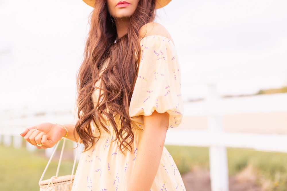 H&M Wildflower Collection Review | Brunette woman wearing a H&M A Meadow of Wildflowers Collection Off-the-shoulder Dress on an acreage with a white fence | H&M Wildflower Collection Canada | H&M Wildflower Collection Canada | Spring/Summer 2021 Trends | The Best Cotton Dresses 2021 | Boho Spring / Summer Outfit Ideas | The Best H&M Dresses Summer 2021 | Alberta Wildflower Field | Cottage Core Fashion | Calgary Creative Lifestyle & Fashion Blogger // JustineCelina.com