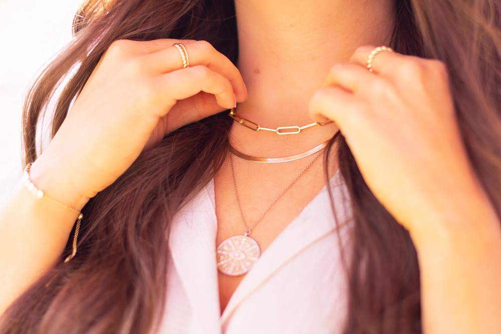 My Joydrop Calgary Jewelry Collection | Brunette woman amongst a blooming cherry blossom tree wearing a Prima Paperclip Necklace, Herringbone Snake Chain Necklace and Gold Coin Eye Pendant Necklace Stack | JustineCelina’s Signature Jewelry | Spring / Summer 2021 Jewelry Trends | Necklace Stack Spring / Summer 2021 | How to layer gold necklaces | Jewelry Trends Summer 2021 | Boho Jewelry Trends 2021 | The Best Gold Plated Jewelry Canada | Calgary Lifestyle and Fashion Blogger // JustineCelina.com