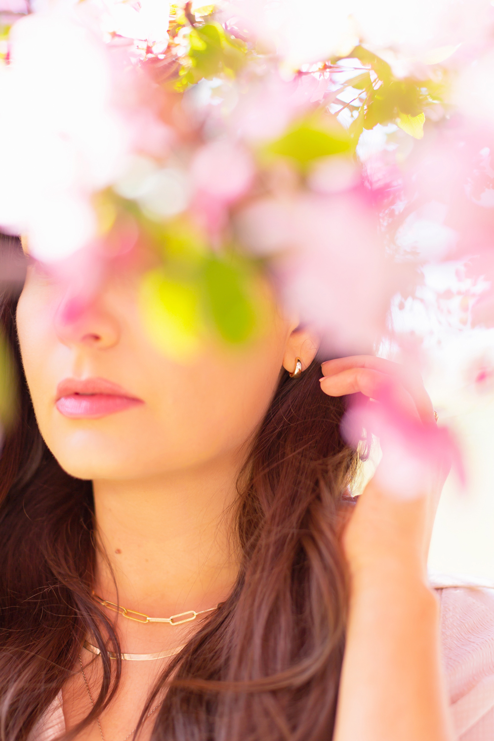 My Joydrop Calgary Jewelry Collection | Brunette woman amongst a blooming cherry blossom tree wearing a gold pair of Prima Plain Huggie Earrings | JustineCelina’s Signature Jewelry | Spring / Summer 2021 Jewelry Trends | Top Accessory Trends Spring / Summer 2021 | The Best Gold Plated Huggies | Jewelry Trends Summer 2021 | Boho Jewelry Trends 2021 | The Best Gold Plated Jewelry Canada | Calgary Lifestyle and Fashion Blogger // JustineCelina.com