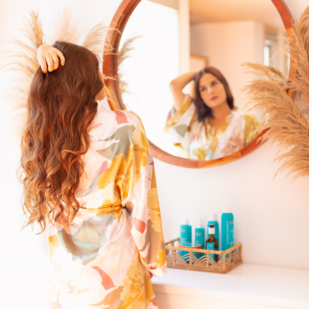 My Haircare Routine for Long Thick Colour Treated Hair | Brunette woman with long, thick wavy hair in a silk robe standing in front of a circular mirror in a sunny boho living room | MoroccanOil haircare routine | BeautySense review | Gentle Haircare Routine | Color-safe, sulphate free, phosphate free and paragon free haircare routine | JustineCelina haircare routine | JustineCelina Hair | Hair growth tips | Hair growth products | Long Hair Secrets | Calgary Beauty Blogger // JustineCelina.com