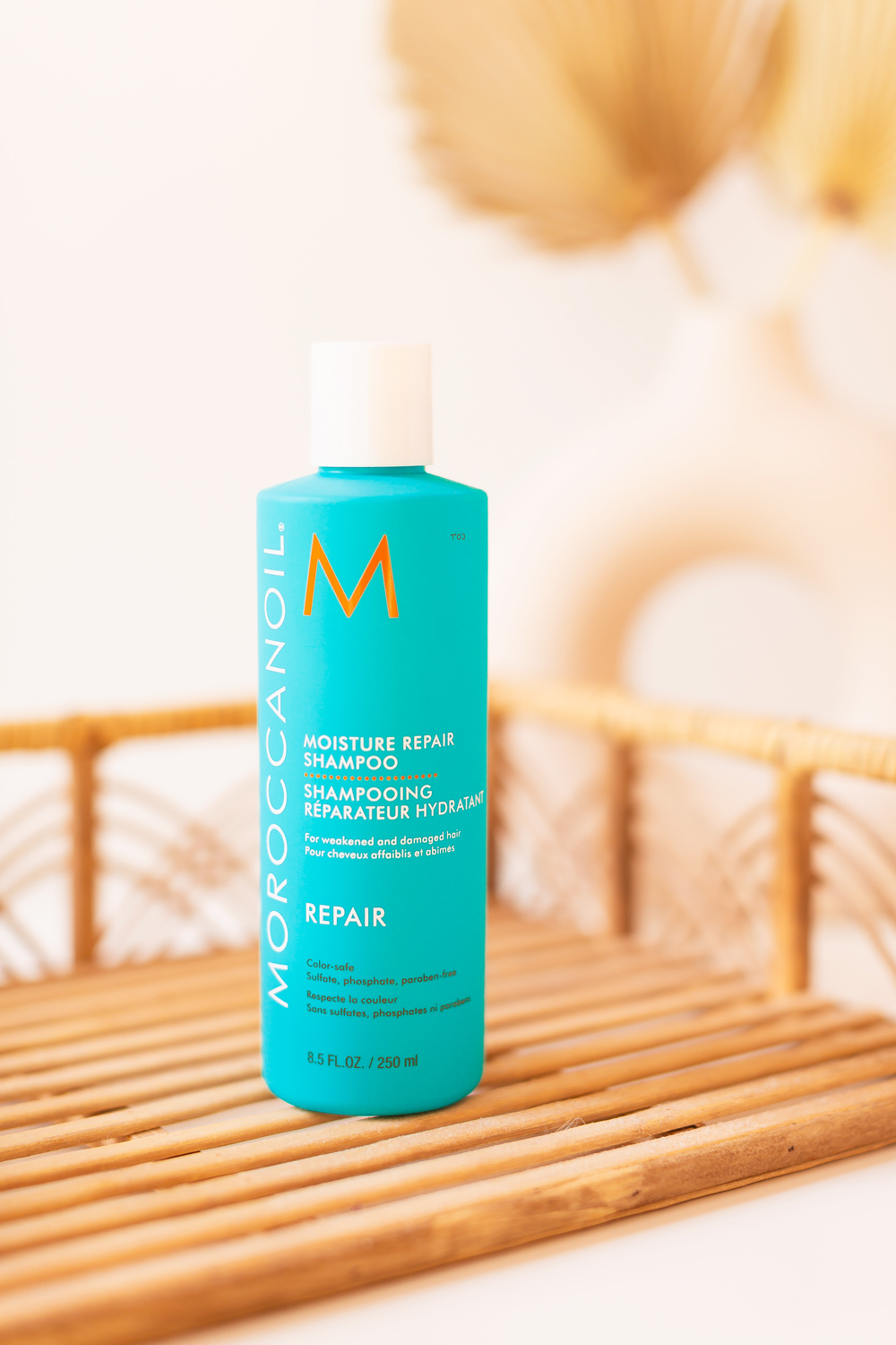 Moroccanoil Moisture Repair Shampoo Photos, Review | Teal blue bottle of shampoo on a boho rattan tray| JustineCelina’s Haircare Routine for Long, Thick, Colour Treated Hair | Color-safe, sulphate free, phosphate free and paraben free haircare routine | MoroccanOil haircare routine | BeautySense review | Gentle Haircare Routine | JustineCelina’s favourite shampoo | JustineCelina Hair | Hair growth tips | Hair growth products | Long Hair Secrets | Calgary Beauty Blogger // JustineCelina.com