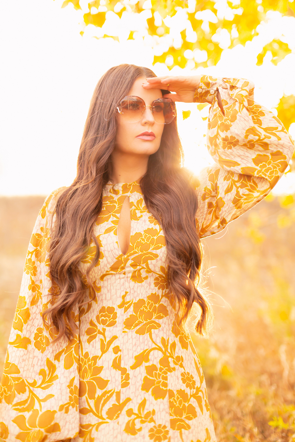 6 Luxe Bohemian Fall Outfits | Autumnal Ochre | Brunette woman wearing a fall floral printed ochre gown with long sleeves and oversized ombre retro inspired sunglasses amongst golden grasses and yellow leaves  | | Boho Fall 2022 Outfit Ideas | Classic Fall Outfit Formulas | Feminine Bohemian Style | Polished Bohemian Style | Elegant Bohemian Style | Bohemian Outfit Ideas | Calgary Alberta Fashion Blogger // JustineCelina.com